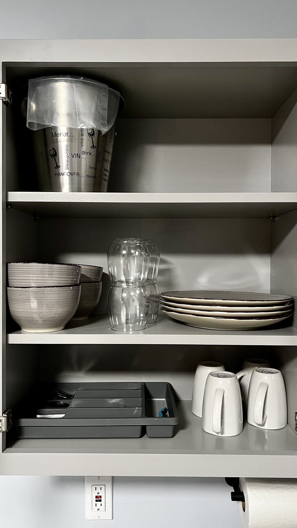 cups, plates, bowls, utensils, ice bucket, bottle opener and paper towel roll