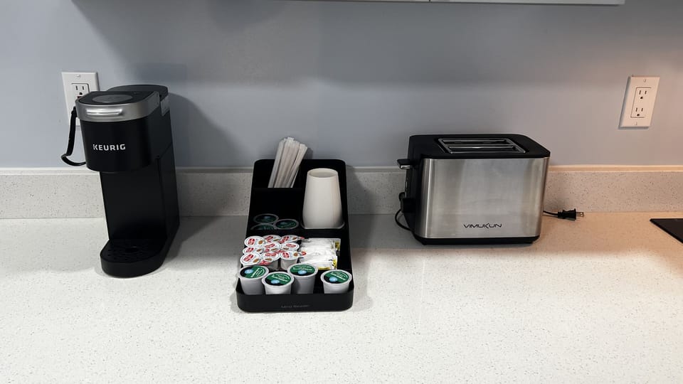 Kitchenette is equipped with mini fridge, microwave, toaster, coffee machine