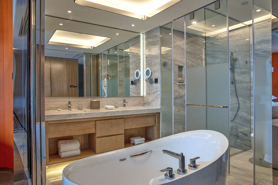Exclusive Room, 1 King Bed, Lake View | Bathroom | Combined shower/tub, rainfall showerhead, hair dryer, bathrobes