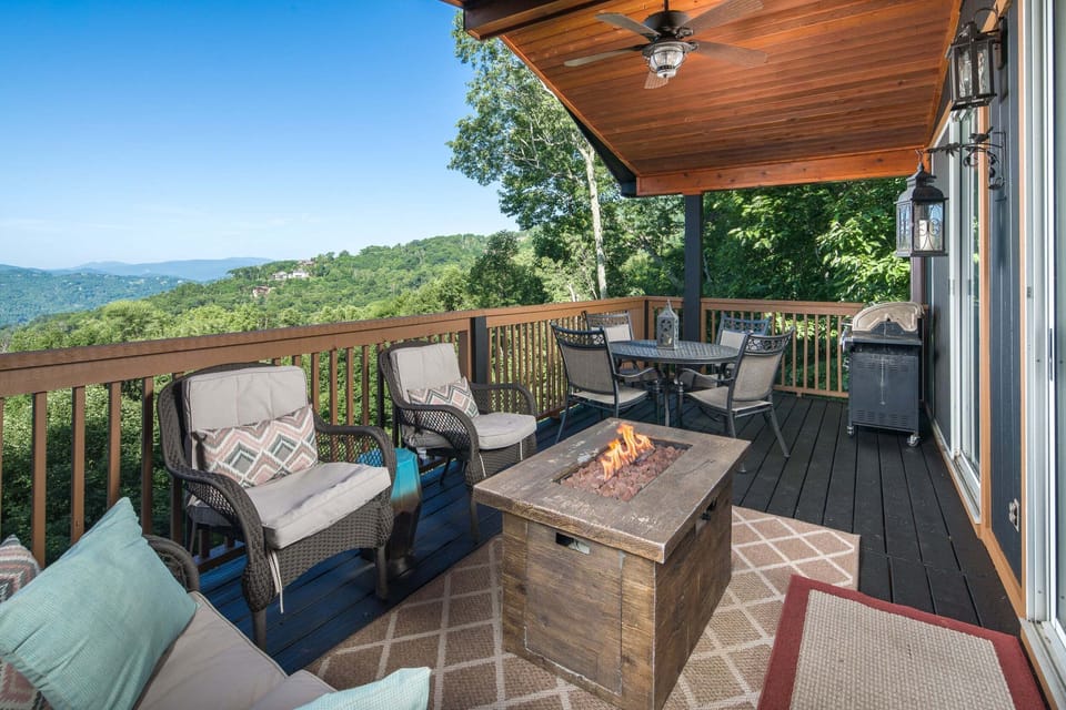 Relax on the covered deck with a fire table and beautiful Blue Ridge Mountain views