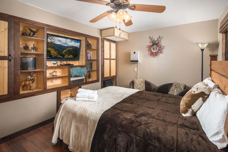 Cozy lower-level guest suite with a queen bed and sitting area