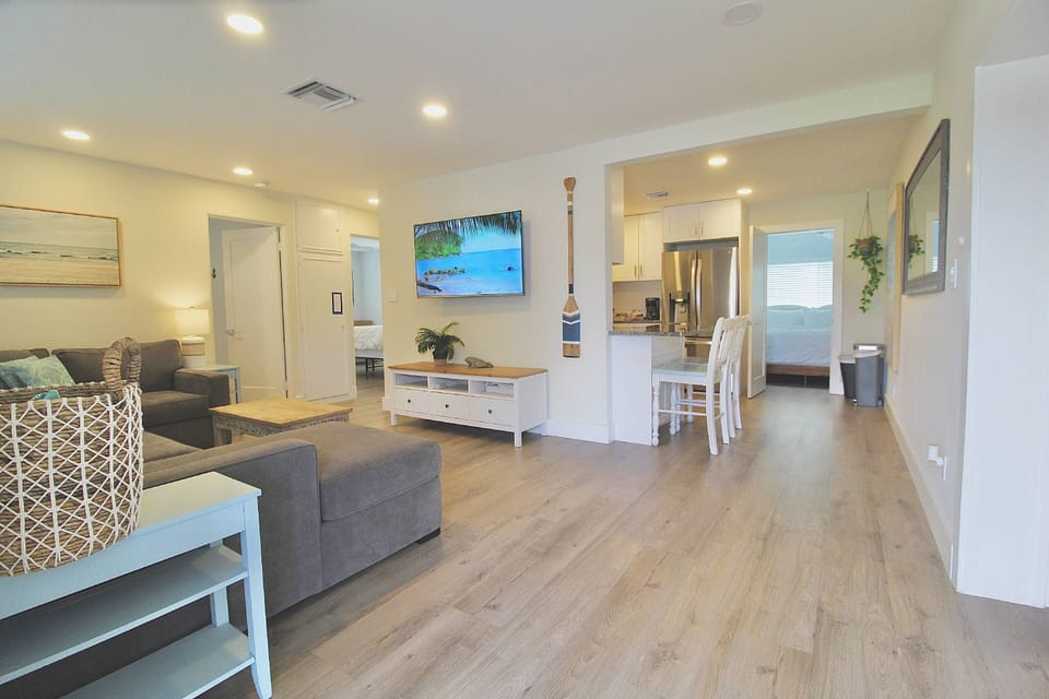 The fully remodeled interior has wood laminate flooring throughout all rooms.