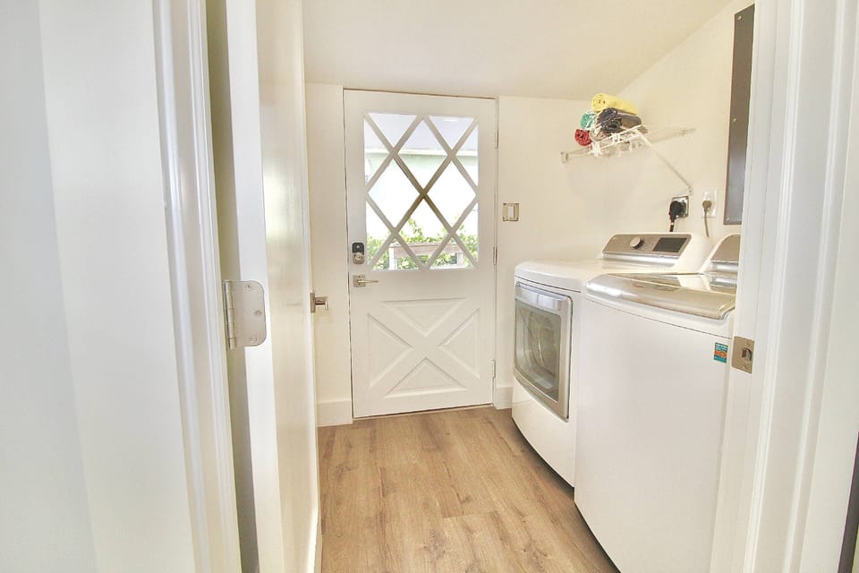 The Laundry Room, with full size washer/dryer, sits off of the Primary Bedroom & has a private door to the back patio.