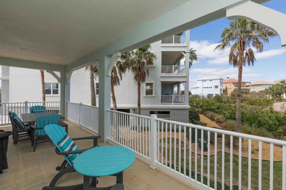 Upscale Patio furniture with rocking chairs and large table and chairs overlooking Golf Course and Atlanic Ocean