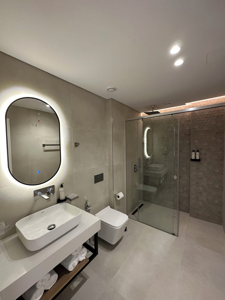 Shower, hair dryer, slippers, towels
