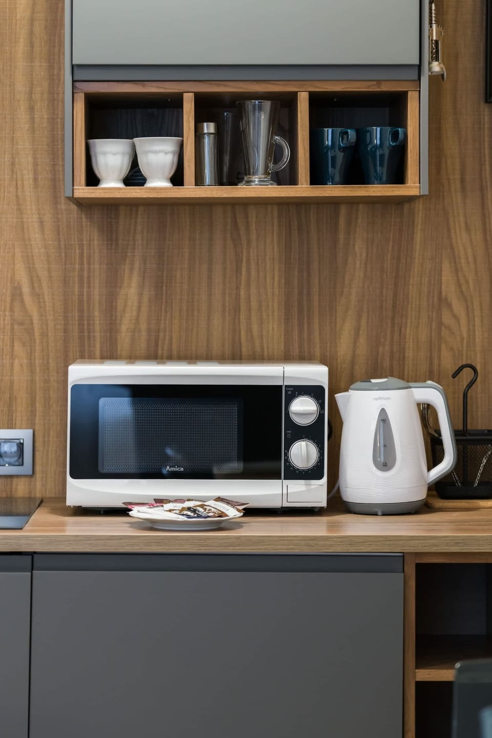 A kitchenette equipped with a microwave, kettle, and coffee maker, offering all the essentials.
