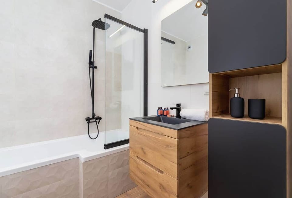 A bathroom with modern fixtures and wooden details.
