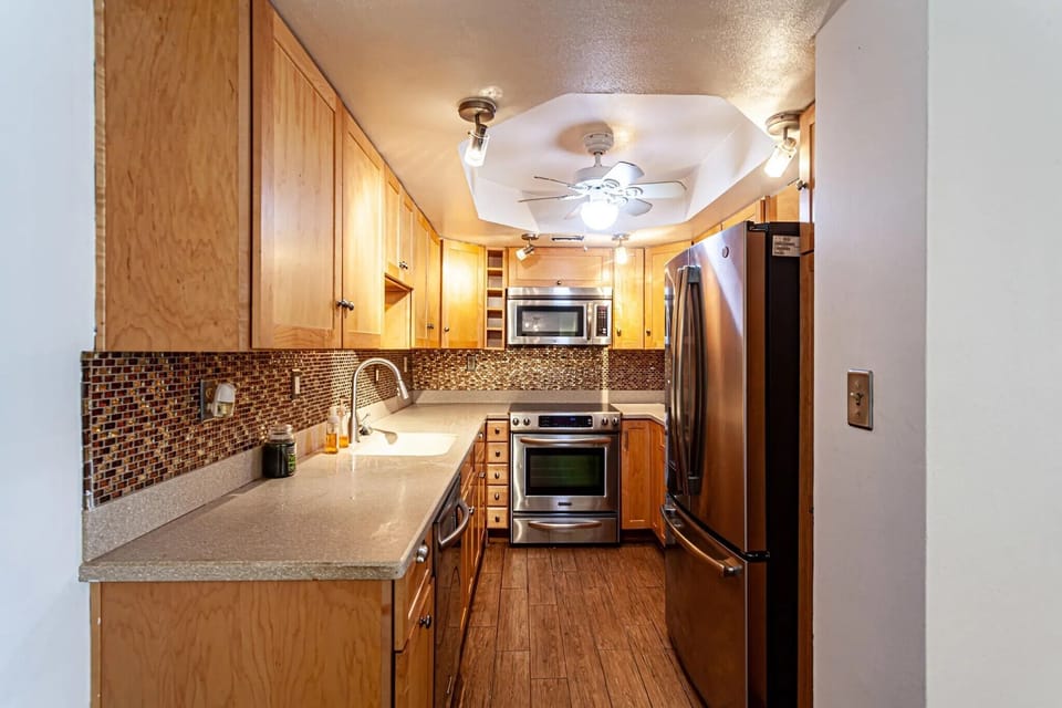 Kitchen1 view of counter top/cabnets/toaster oven/microwave/stove/fridge