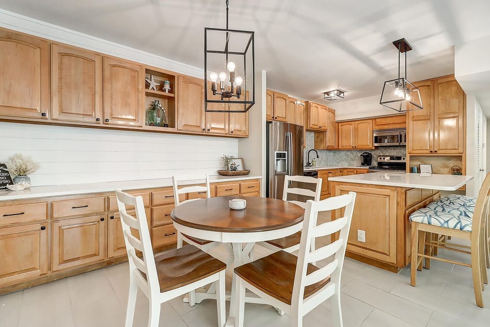 Your spacious kitchen welcomes you with warm wood cabinets, granite counters, and a cozy breakfast nook perfect for morning coffee.