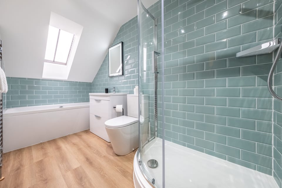 First floor: A fully tiled bathroom with bath and shower options