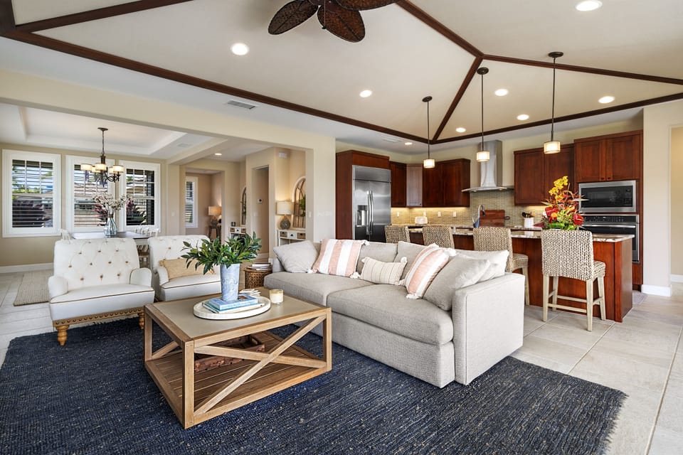 Open concept living area with vaulted ceilings flowing into the kitchen and dining space.
