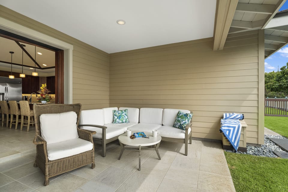 Covered lanai seating area ideal for morning coffee or evening relaxation.