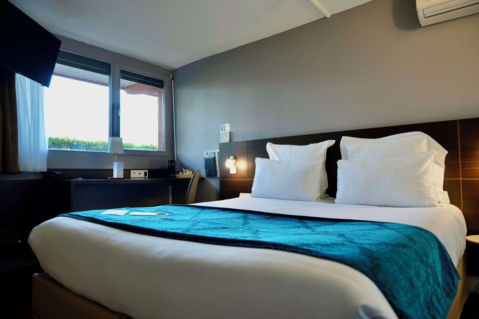 Premium bedding, desk, laptop workspace, blackout drapes