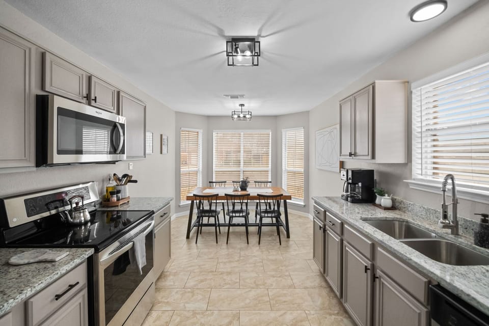 Sunlit kitchen and dining nook with modern flair, perfect for culinary adventures and gatherings!