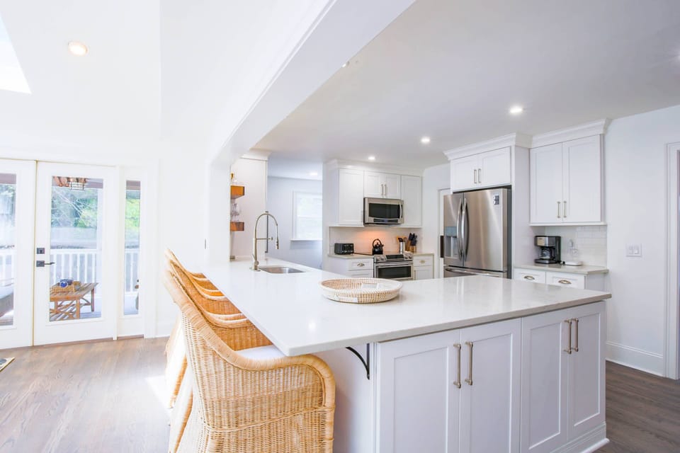 The kitchen features new countertops & cabinetry, stainless steel appliances and island seating.