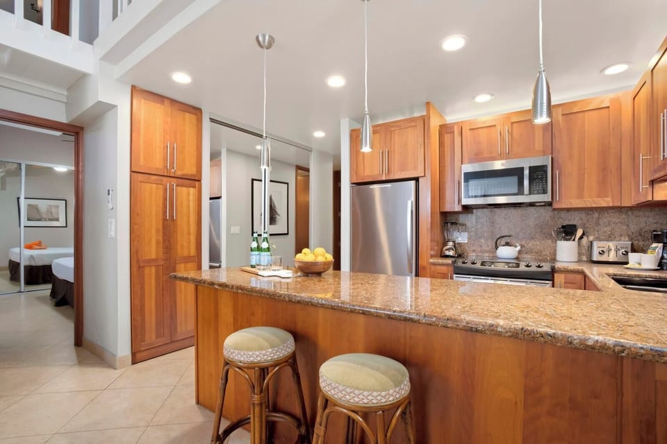  From the stainless fridge to the wood-paneled island, every detail in this kitchen is built for comfort and style  