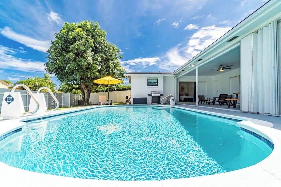 "Sparkling private pool with crystal-clear waters, surrounded by lush landscaping and covered patio seating. This stunning vacation rental offers your own tropical oasis for swimming, sunbathing, and creating unforgettable Florida memories!"