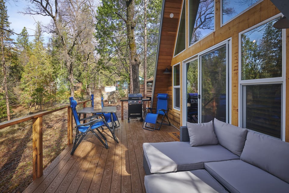 Back deck with outdoor furniture and grill to relax and enjoy the woodsy nature