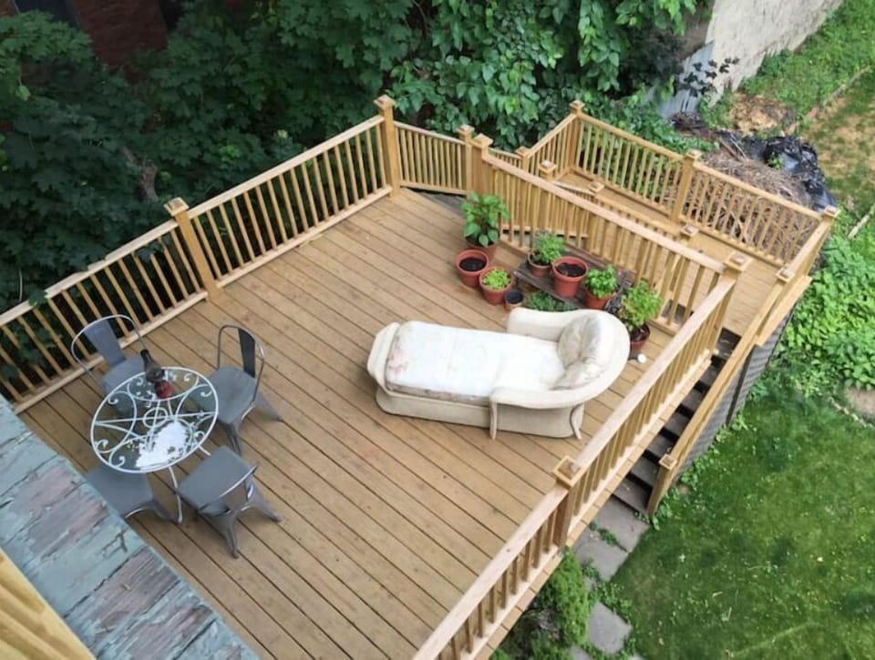Patio outside kitchen with bbq grill and herbs for cooking 