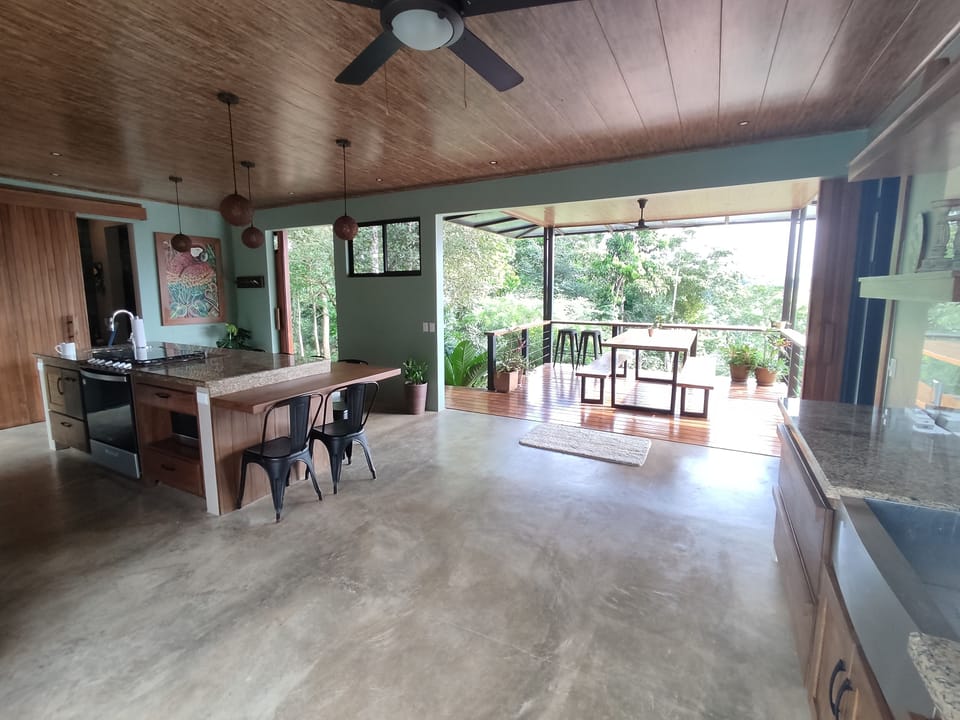 Kitchen area, island bar, and breakfast patio. 