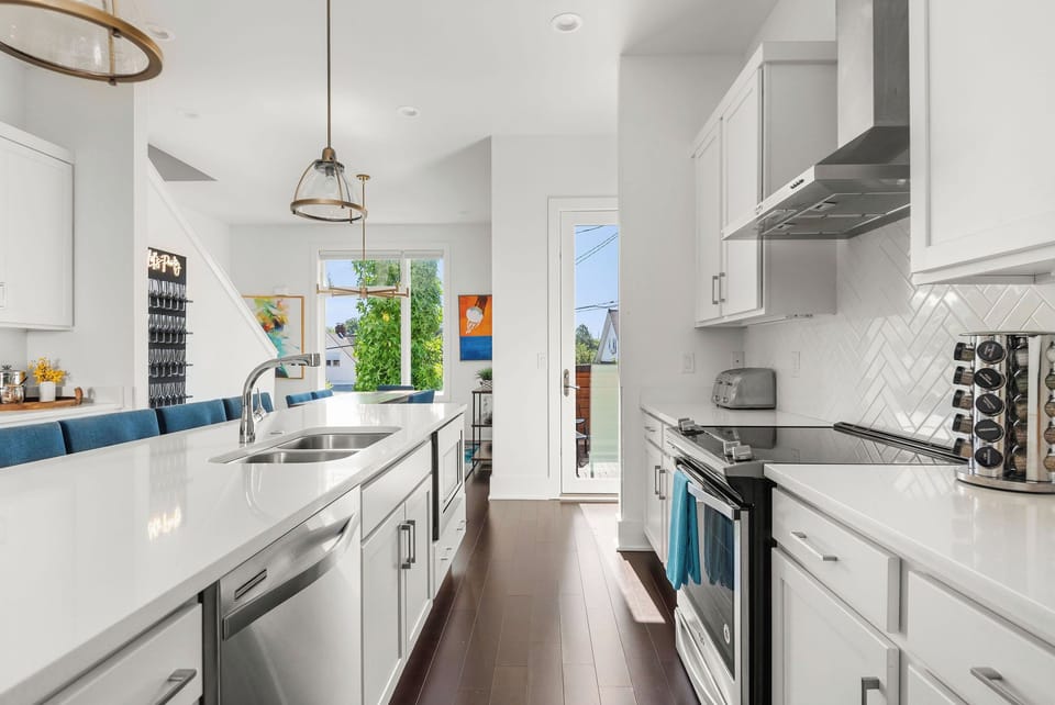 - Sleek kitchen with bright counters and stainless appliances   - Island seating and open flow ideal for cooking and gathering   - Sunlit windows bring a warm feel to your vacation meal prep