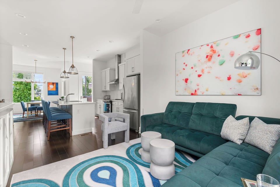 - Open layout connecting living room and kitchen beautifully   - Modern seating and colorful art enhance your stay   - Great vacation rental space for groups and families