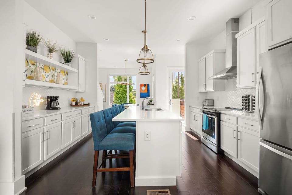 - Spacious kitchen with bright cabinets and sleek appliances   - Large island seating ideal for group cooking and dining   - Modern vacation rental setup with stocked essentials