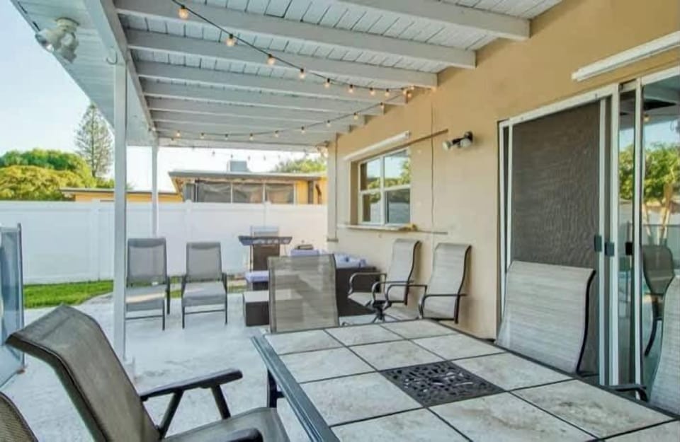 "Enjoy al fresco dining on our covered patio! 🍹 Complete with string lights and a BBQ grill, this outdoor living space is ideal for evening relaxation. Your perfect home away from home awaits! ✨"
