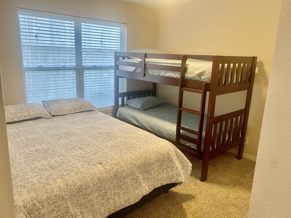 Secondary bedroom with queen bed and twin bunk beds