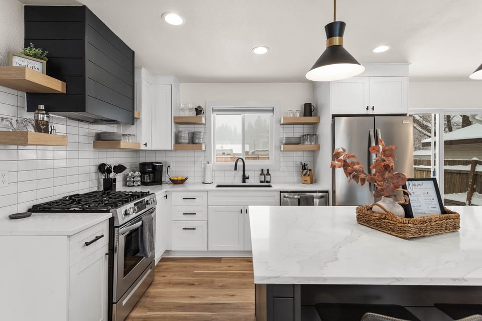 Fully equipped kitchen with gas stove, dish washer, refrigerator, and microwave.