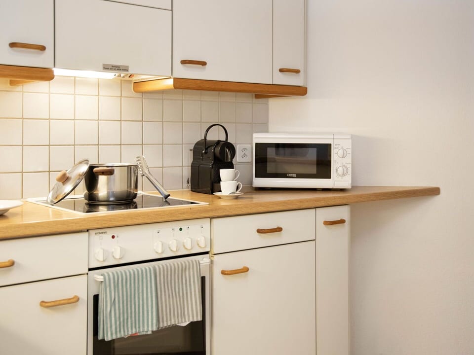 Kitchen, Wood, Cabinetry, Countertop, Kitchen Appliance, Furniture, Interior Design, Flooring, Major Appliance, Lighting