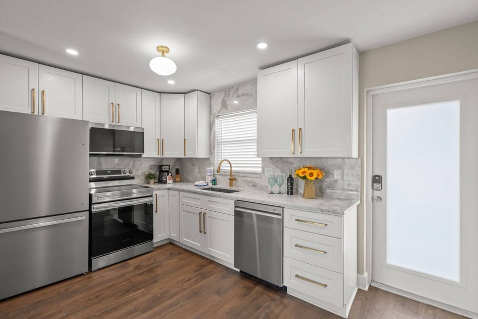 Open kitchen updated and modern! Stocked with dishes, pots & pans