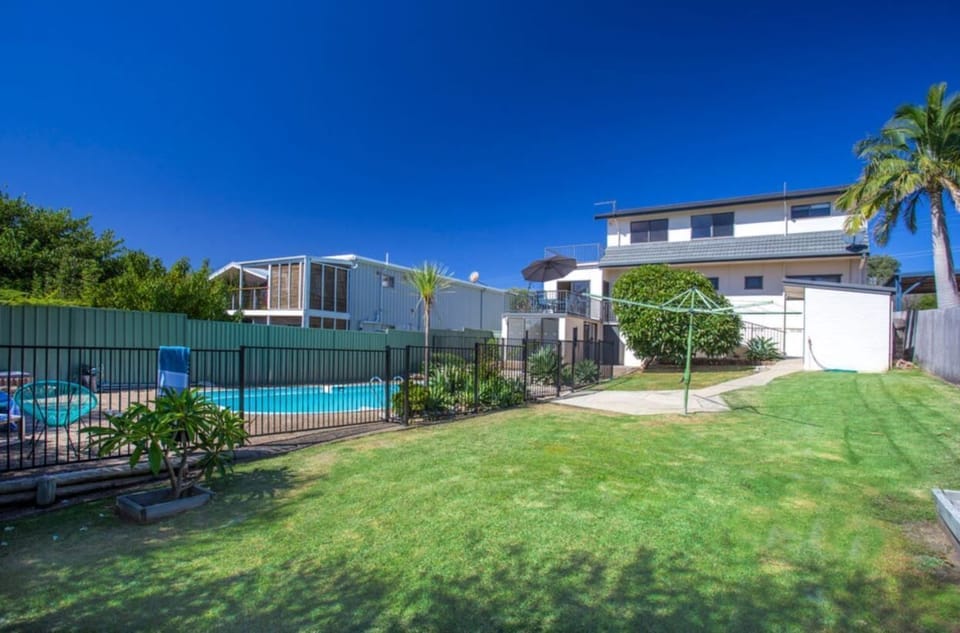 A private and enclosed fully fenced back yard to run around and play ball sports