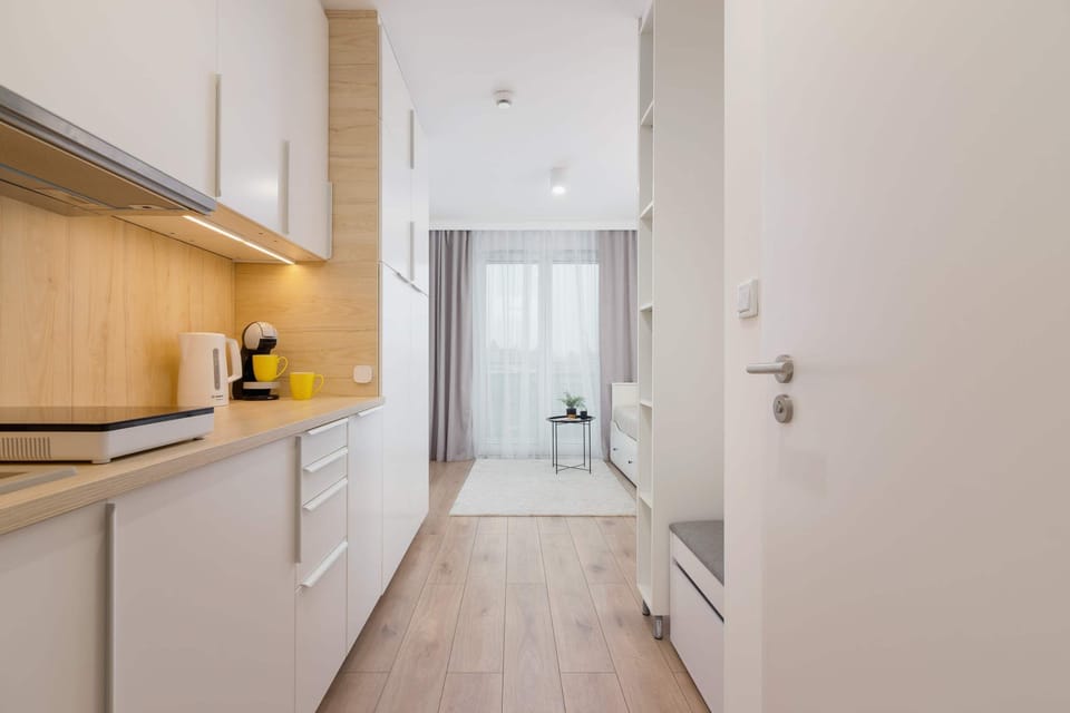 A functional kitchenette with ample counter space, modern appliances, and a sleek design.

