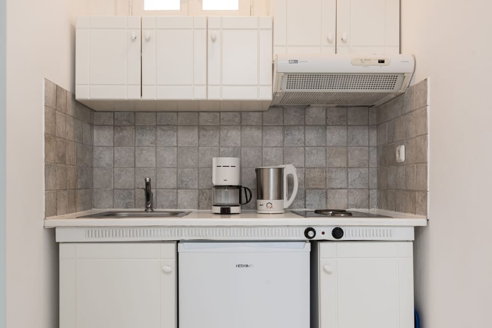 Standard Triple Room | Private kitchen | Coffee/tea maker, electric kettle, highchair