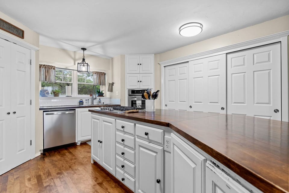 The kitchen is well stocked with pots and pans and a gas stove top.