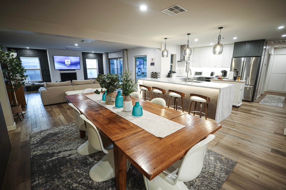 Dining table for eight beside the kitchen and open living spaces.