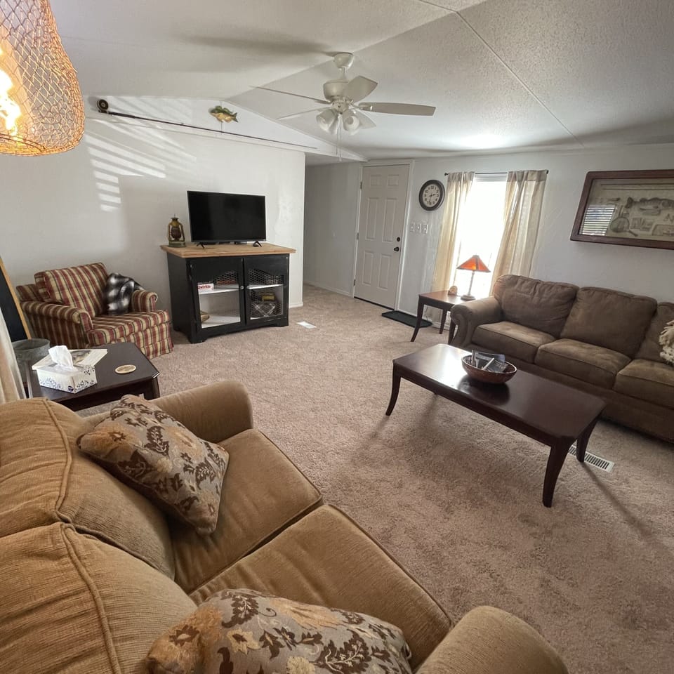 Large living room with ample seating, TV, books, games - and blankets!