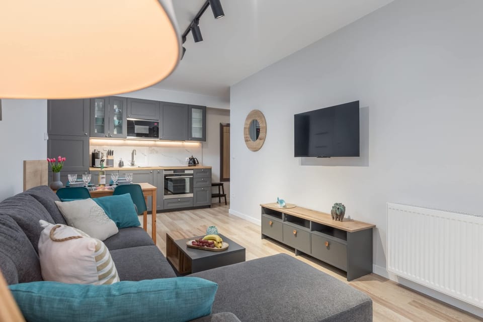A close-up of the living area with a flat-screen TV, modern furniture, and decorative accents.
