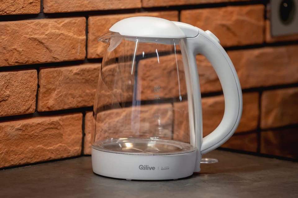 A close-up of a glass electric kettle placed on the countertop, emphasizing functionality.
