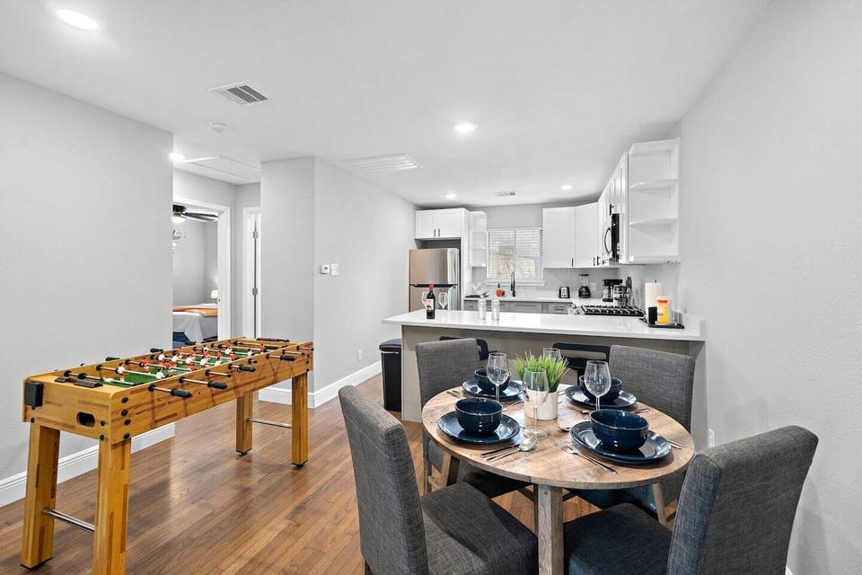 Spacious dining table with full tableware and silverware included.