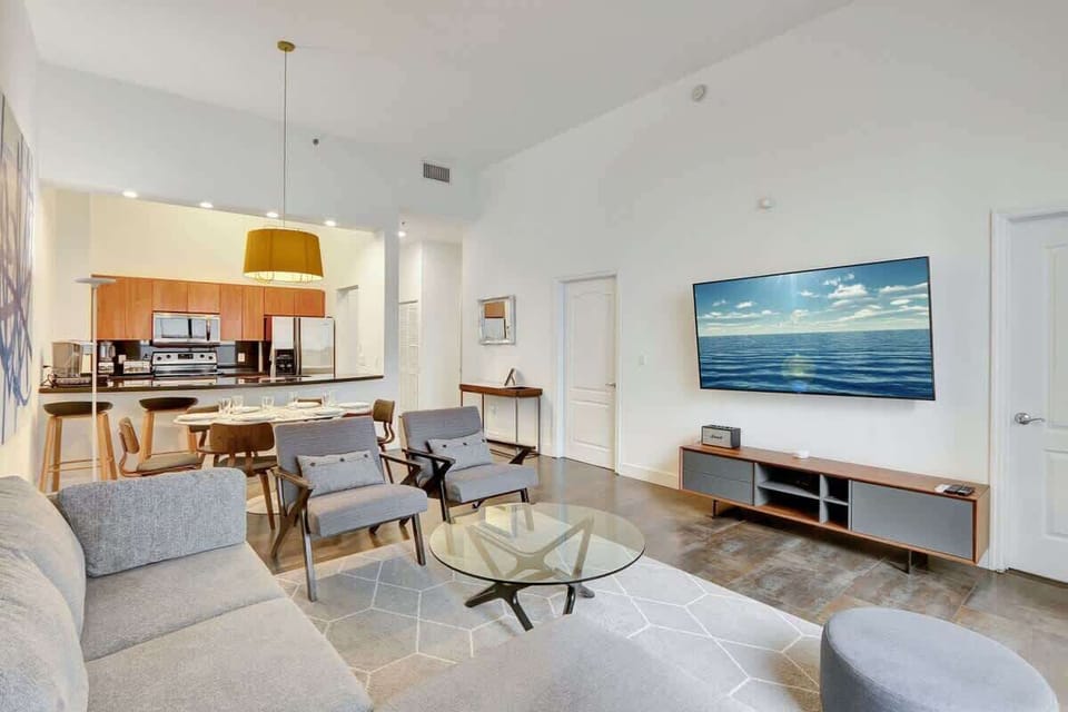 Spacious open concept interior featuring a living area with sofa bed, cozy dining area, and a fully equipped kitchen.