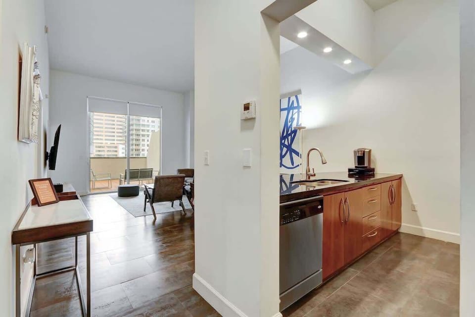 Spacious open concept interior featuring a living area with sofa bed, cozy dining area, and a fully equipped kitchen.