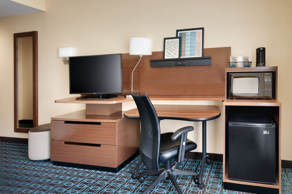 Desk, laptop workspace, iron/ironing board, free cribs/infant beds