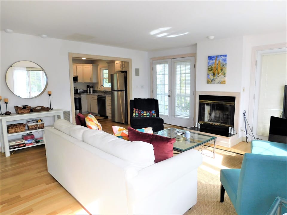 9 South Seventh Street - Living Room Overview - An overview of the main living space showing the bright, open seating area with a sofa, armchairs, and abundant natural light.