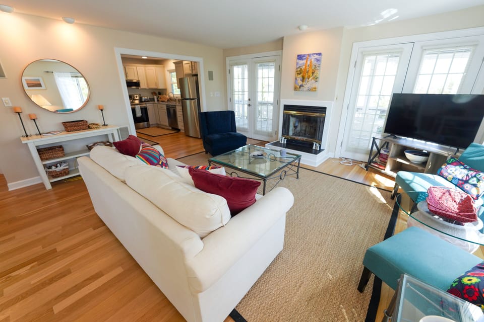 9 South Seventh Street - Fireplace Lounge - A focused view of the lounge area showcasing the fireplace, media setup, and hardwood flooring.