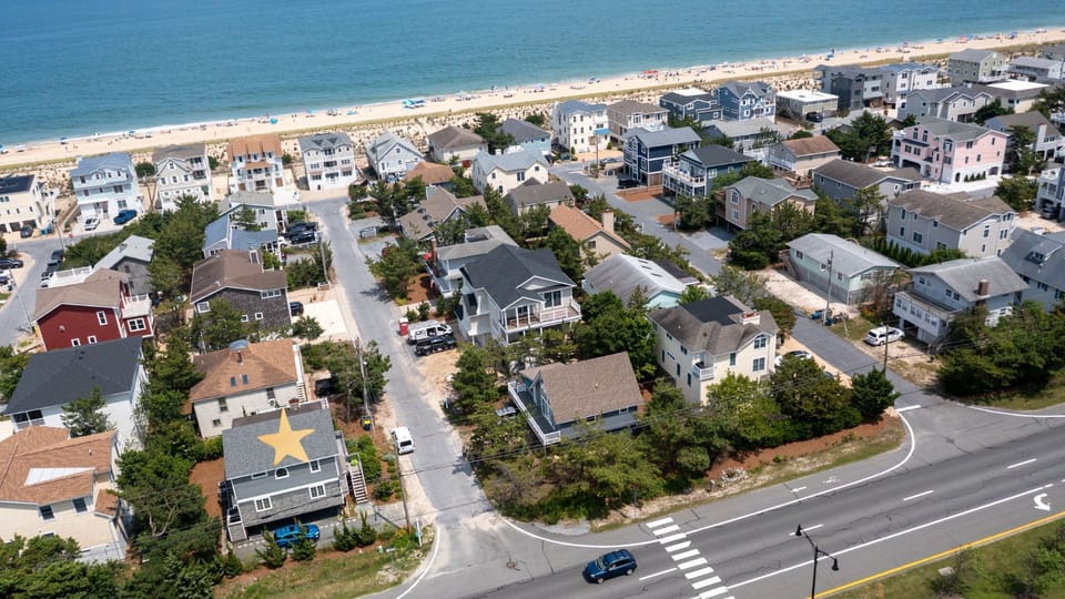 9 South Seventh Street - Drone View of Beach and Coastline - Wide aerial view looking over the neighborhood toward the ocean, emphasizing the property's short distance from the beach.