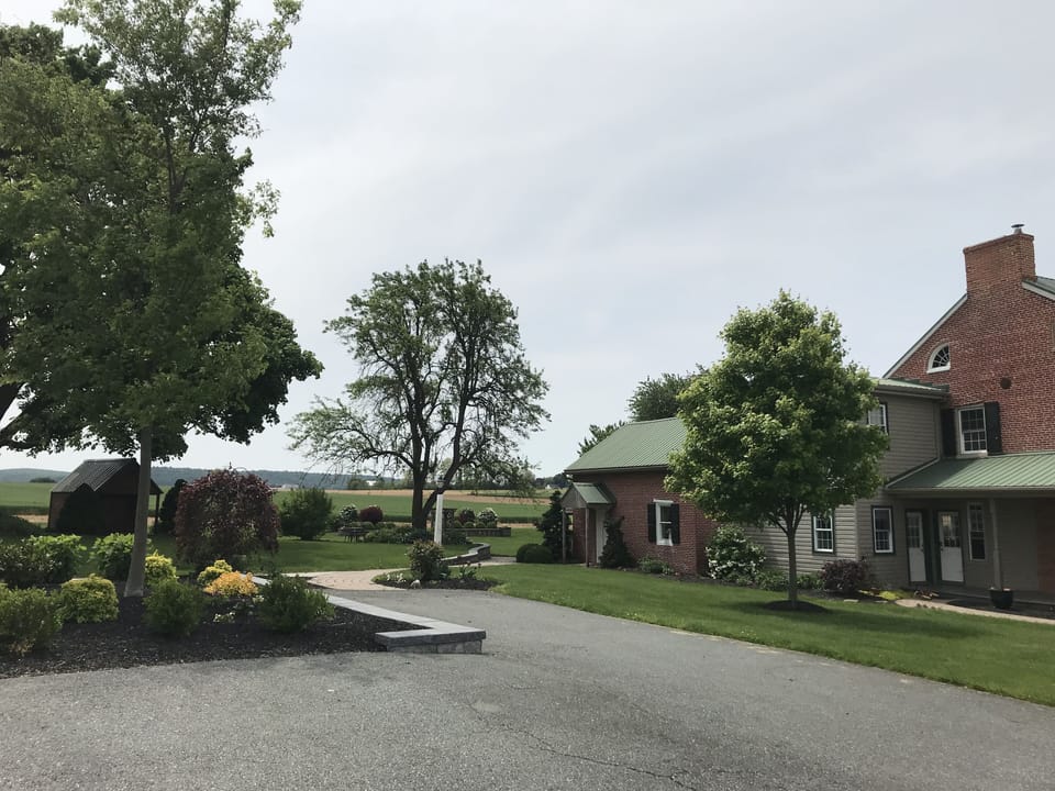 Parking spot is beside the patio, with a paved path leading to the entrance
