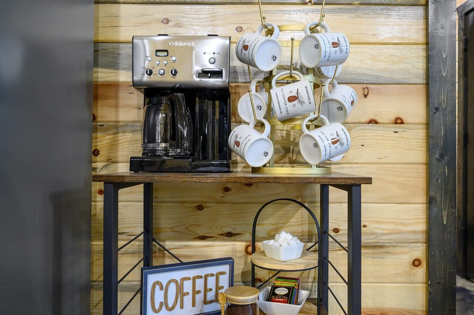 Your morning just got easier—fresh coffee, tea, and all the fixings are ready and waiting at the cozy cabin coffee bar.