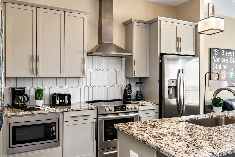 Fully equipped kitchen with brand-new stainless steel appliances for group cooking.